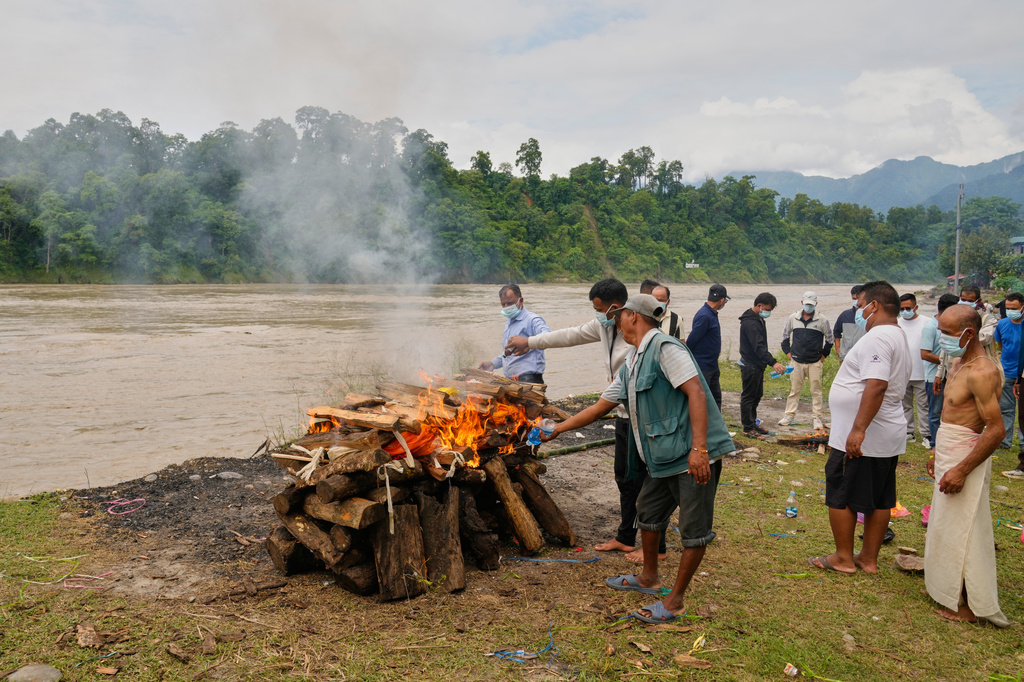 Relatives and friends cremate Aayush Khada, who was killed in flash floods, in Chitwan, Nepal, Monday, Aug. 31, 2026. (AP Photo/Dar Yasin)