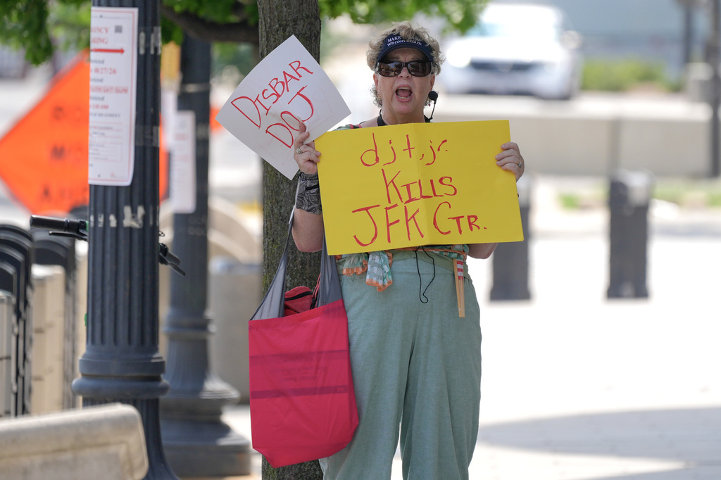 Clara Sachs, protests outside of the Federal Courthouses as Commerce Secretary Howard Lutnick speaks with reporters before a hearing to allow President Donald Trump's name to be on the Kennedy Center, Thursday, Aug. 27, 2026, in Washington. (AP Photo/Mariam Zuhaib)