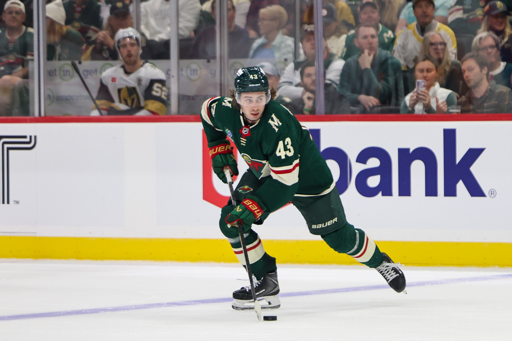 Minnesota Wild defenseman Quinn Hughes (43) skates with the puck during the first period of an NHL hockey game against the Vegas Golden Knights, Monday, Oct. 12, 2026, in St. Paul, Minn. (AP Photo/Michael Turner)