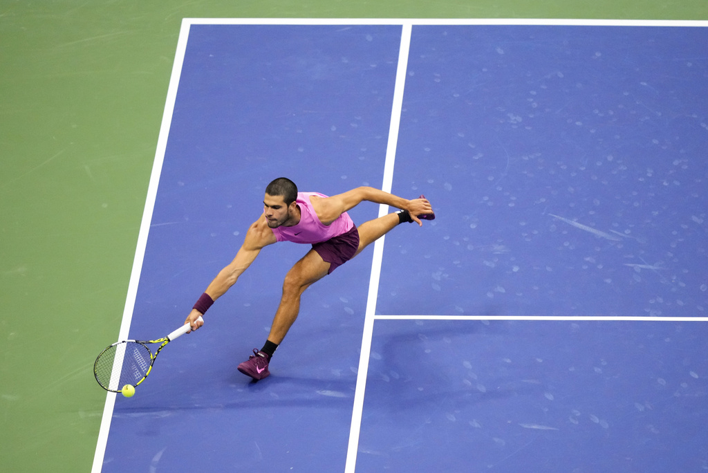 Carlos Alcaraz, of Spain, chases down a shot from Jannik Sinner, of Italy, during the men's singles final of the U.S. Open tennis championships, Sunday, Sept. 7, 2025, in New York. (AP Photo/Yuki Iwamura)