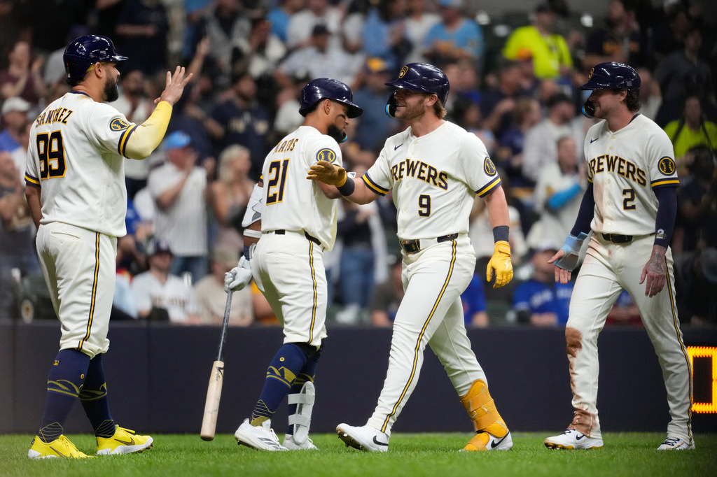 Milwaukee Brewers' Jake Bauers (9) is congratulated by teammates after hitting a three-run home run during the fourth inning of a baseball game against the Toronto Blue Jays, Tuesday, April 14, 2026, in Milwaukee. (AP Photo/Aaron Gash)