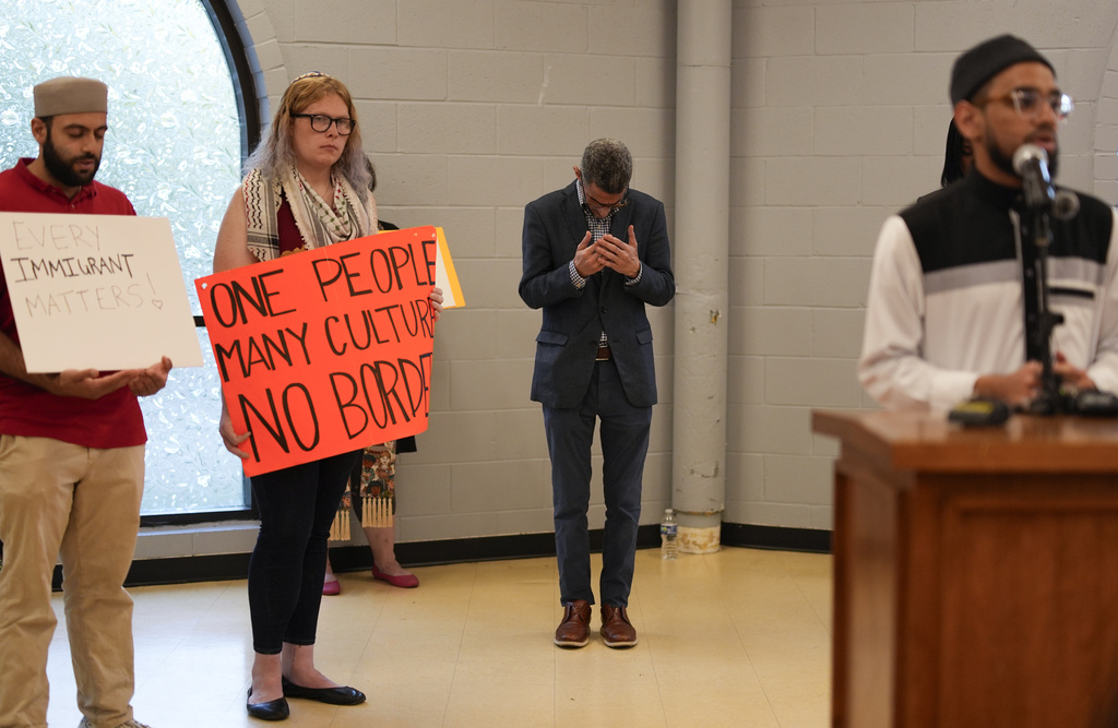 Ayman Soliman, third from left, prays with others at the close of a news conference, after being released from ICE Custody, at the Clifton Mosque on Friday, Sept. 19, 2025, in Cincinnati. (AP Photo/Carolyn Kaster)
