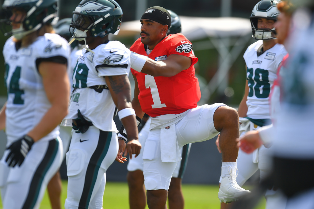 Philadelphia Eagles quarterback Jalen Hurts (1) warms up with teammates during a joint NFL football practice with the New England Patriots, Thursday, Aug. 20, 2026, in Foxborough, Mass. (AP Photo/Steven Senne)