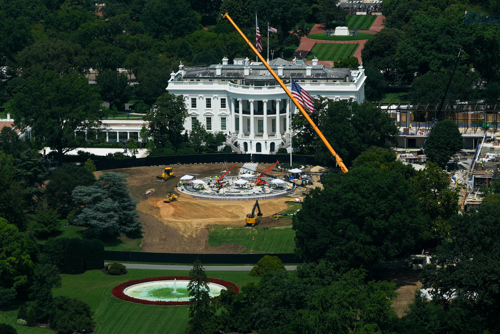 Workers build a helipad on the South Lawn of the White House, left, and continue construction on the new White House ballroom, right, as seen from the Washington Monument, Monday, Aug. 17, 2026, in Washington. (AP Photo/Julia Demaree Nikhinson)