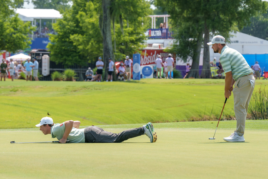 Matt Fitzpatrick, left, of England, lines up a putt with his brother Alex Fitzpatrick, right, at the ninth hole during the final round of the PGA Zurich Classic of New Orleans golf tournament, Sunday, April 26, 2026, in Avondale, La. (AP Photo/Matthew Hinton)
