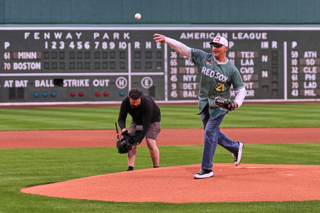 Former Boston Red Sox pitcher Roger Clemens, right, throws out a ceremonial first pitch prior to a baseball game against the Minnesota Twins, Friday, May 22, 2026, in Boston. (AP Photo/Charles Krupa)