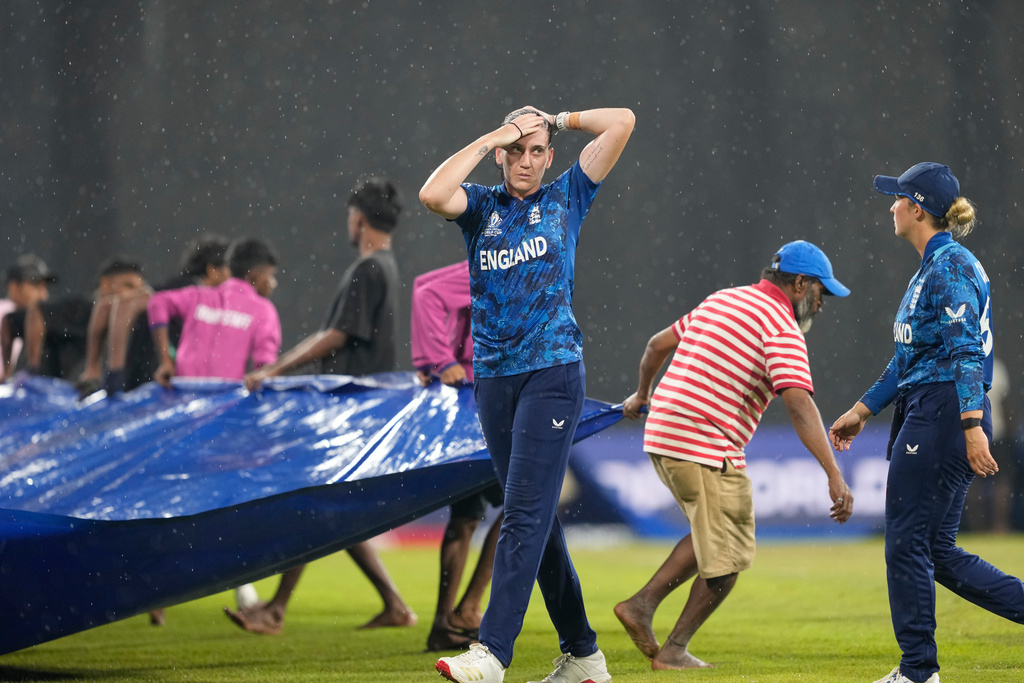 England's Em Arlott leaves the field as it rains during the ICC Women's Cricket World Cup match between England and Pakistan at Premadasa Stadium in Colombo, Sri Lanka, Wednesday, Oct, 15, 2025. (AP Photo/Eranga Jayawardena)