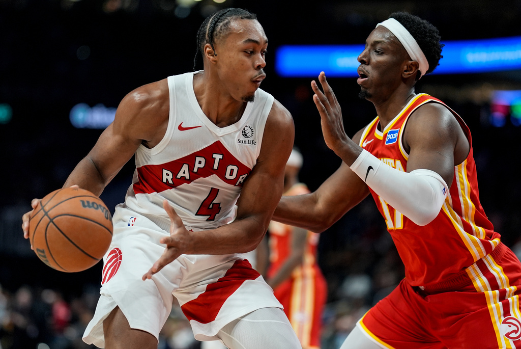 Toronto Raptors forward Scottie Barnes (4) drives against Atlanta Hawks forward Onyeka Okongwu (17) during the first half of an NBA basketball game, Wednesday, Oct. 22, 2025, in Atlanta. (AP Photo/Mike Stewart)
