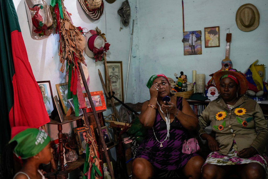 Revelers prepare to take part in the Afro-Venezuelan Holy Innocents' Day celebration in Caucagua, Venezuela, Sunday, Dec. 28, 2025. (AP Photo/Matias Delacroix)