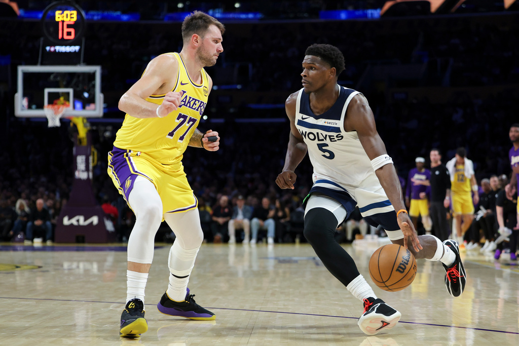 Minnesota Timberwolves guard Anthony Edwards (5) dribbles against Los Angeles Lakers guard Luka Doncic (77) during the second half of an NBA basketball game, Friday, Oct. 24, 2025, in Los Angeles. (AP Photo/Jessie Alcheh)