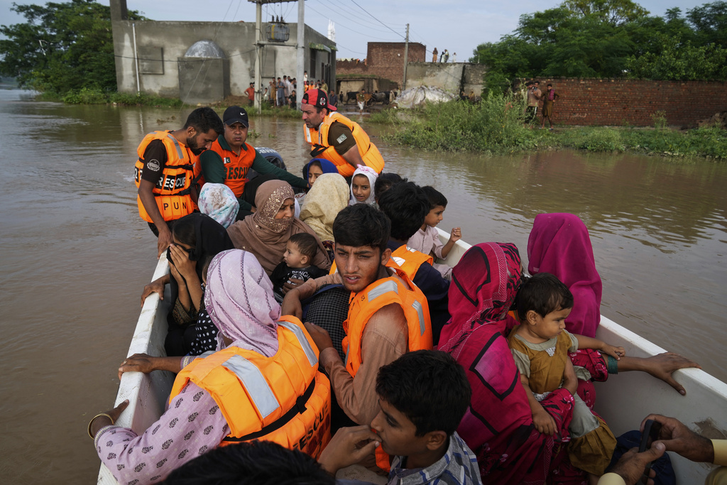Rescue workers evacuate villagers from a flooded area in Chango Walia village in Narowal district, Pakistan, Wednesday, Aug. 27, 2025. (AP Photo/K.M. Chaudary)