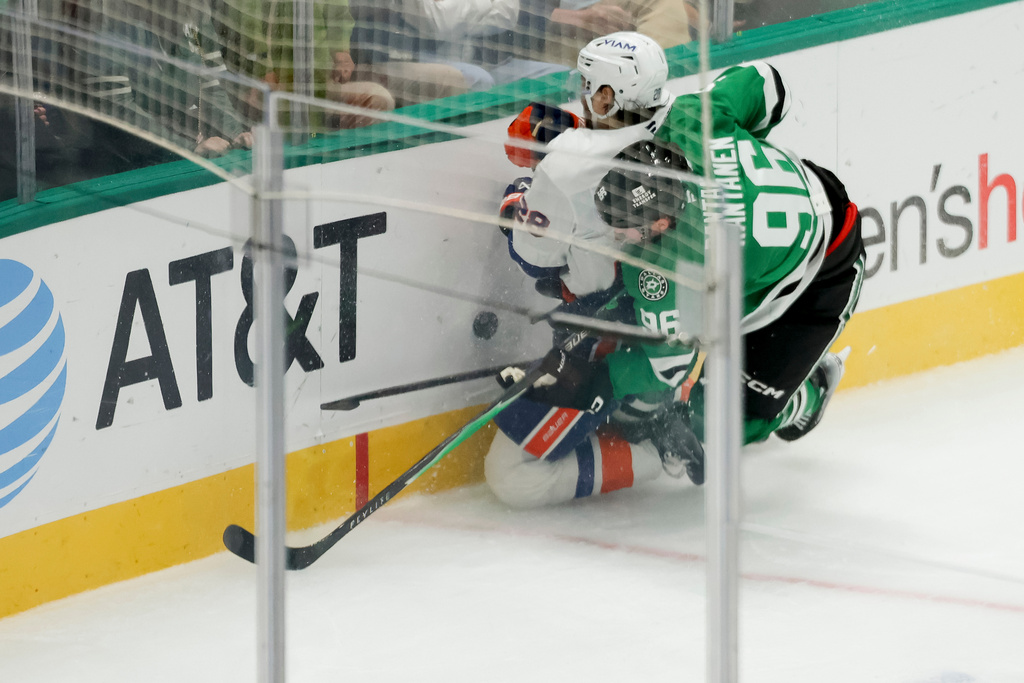 Dallas Stars right wing Mikko Rantanen (96) collides with New York Islanders defenseman Alexander Romanov (28) during the third period of an NHL hockey game, Tuesday, Nov. 18, 2025, in Dallas. (AP Photo/Gareth Patterson)