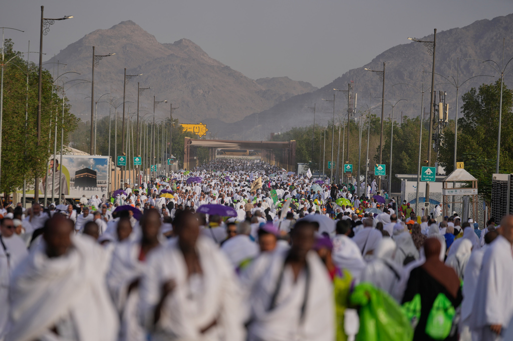 Muslim pilgrims walk towards the rocky hill known as the Mountain of Mercy, on the Plain of Arafat, during the annual Hajj pilgrimage near the holy city of Mecca, Saudi Arabia, Tuesday, May 26, 2026. (AP Photo/Altaf Qadri)