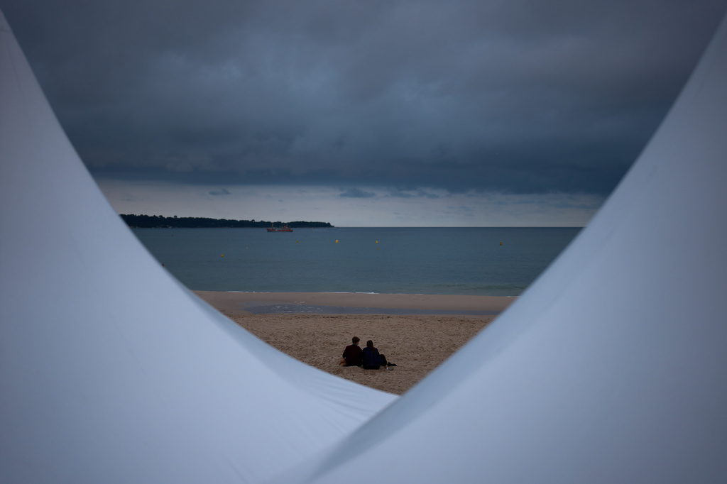 People sit on a beach along the Croisette ahead of the 79th Cannes international film festival Sunday, May 10, 2026, in Cannes, southern France. (AP Photo/John Locher)