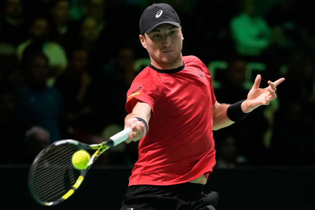 Belgium's Raphael Collignon returns a ball to Italy's Matteo Berrettini during a Davis Cup semifinal singles tennis match between Italy and Belgium, in Bologna, Italy, Friday, Nov. 21, 2025. (AP Photo/Luca Bruno)