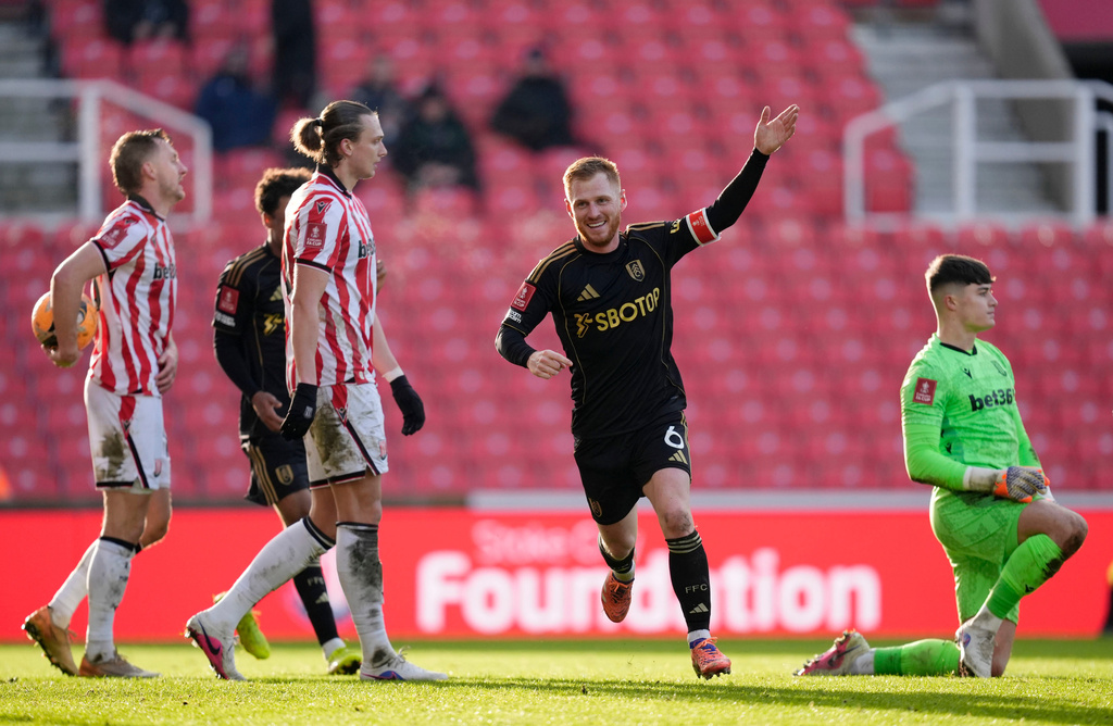 Fulham's Harrison Reed celebrates after scoring his sides second goal during the English FA Cup fourth round match between Stoke City and Fulham, in Stoke, England, Sunday, Feb. 15, 2026. (Nick Potts/PA via AP)