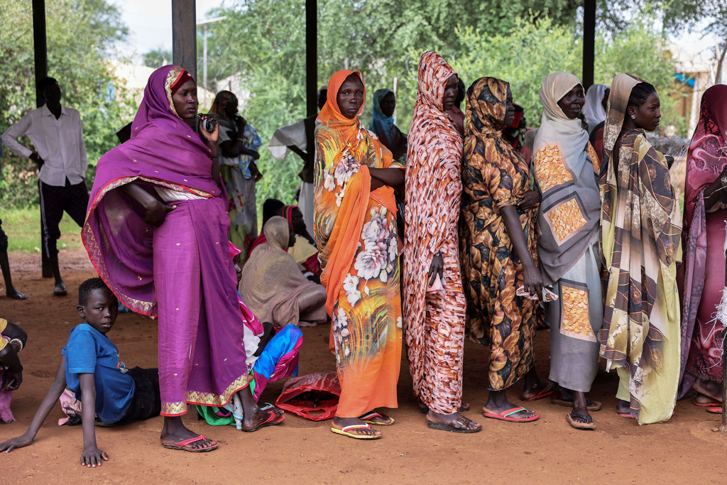 Women wait for cash assistance and dry grain from the U.N. World Food Programme in Gendrassa refugee camp, Maban, South Sudan, Wednesday, Aug. 20, 2025. (AP Photo/Caitlin Kelly)