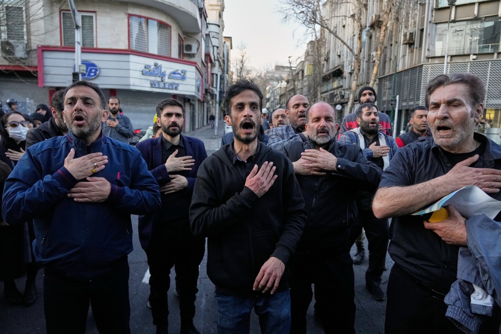 A group of men beat their chests as a sign of grief and mourning near the residency of the late Iranian Supreme Leader Ayatollah Ali Khamenei in Tehran, Iran, Sunday, March 1, 2026, in the aftermath of his confirmed death in U.S. and Israeli strikes. (AP Photo/Vahid Salemi)