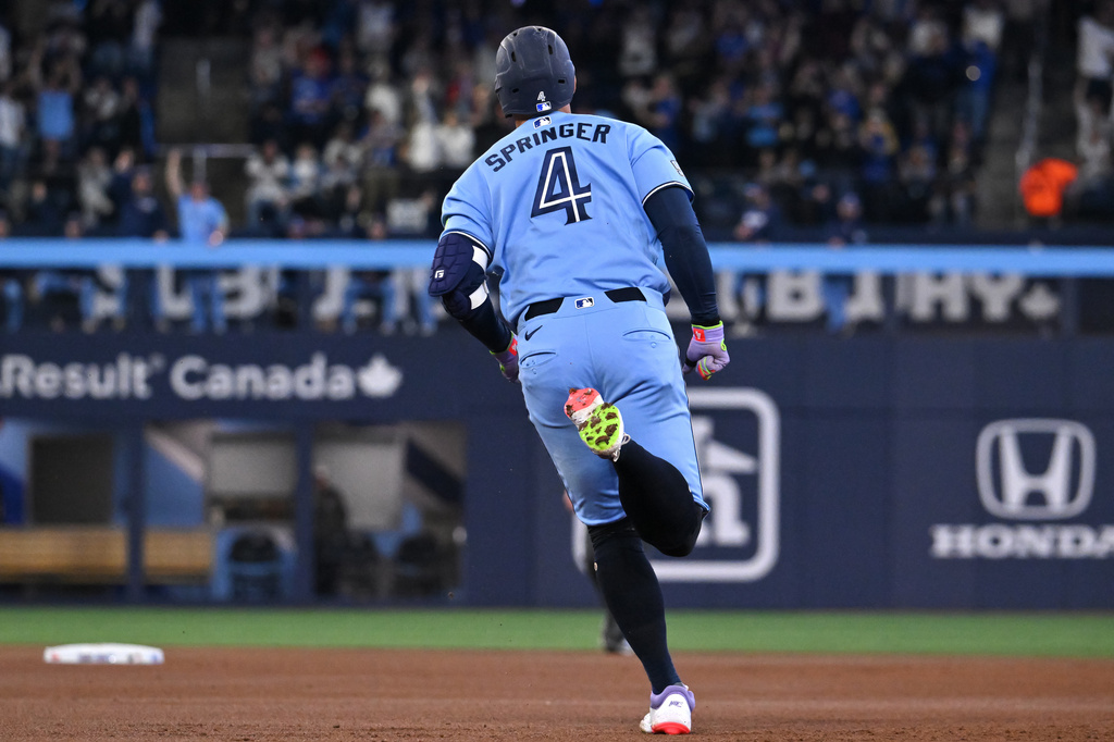 Toronto Blue Jays' George Springer (4) runs the bases after hitting a solo home run against the Pittsburgh Pirates during the first inning of a baseball game in Toronto, Saturday, May 23, 2026. (Jon Blacker/The Canadian Press via AP)