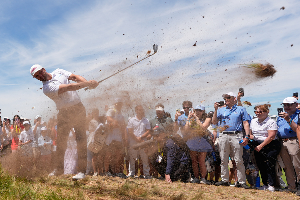 Wyndham Clark hits from the rough on the 14th hole during the second round of the U.S. Open golf tournament at Shinnecock Hills Golf Club in Southampton, N.Y., Friday, June 19, 2026.(AP Photo/David J. Phillip)