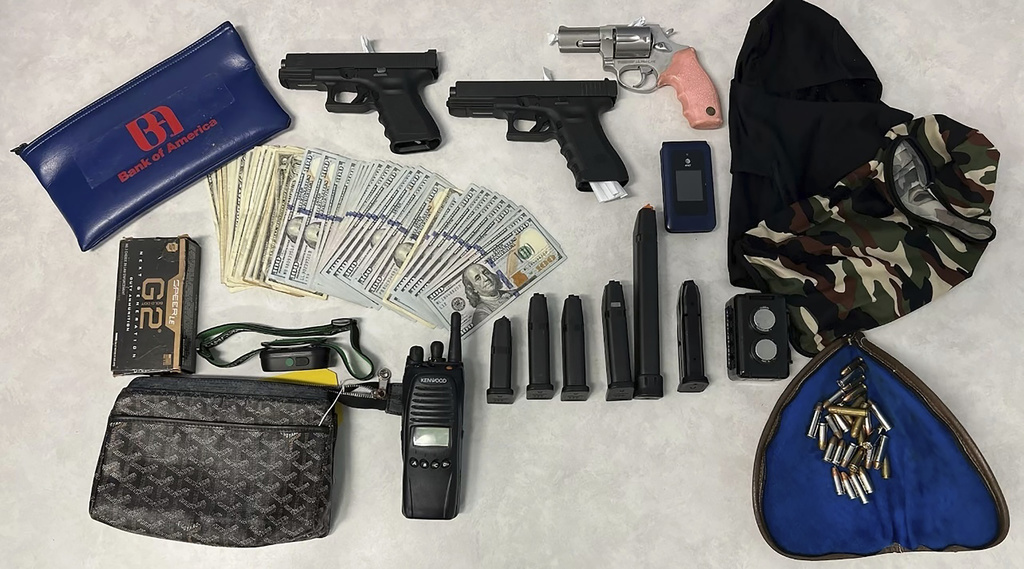 This undated photo provided by the Los Angeles Police Department shows firearms, cash, and stolen valuables recovered from an operation on Wednesday, Aug. 20, 2025, that led to the arrests of members of a burglary crew suspected of nearly 100 break-ins in the Los Angeles area. (LAPD via AP)