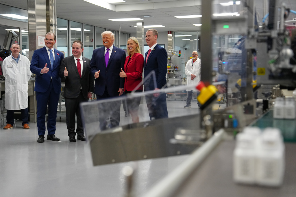 President Donald Trump poses for a photo during a visit to Thermo Fisher Scientific, Wednesday, March 11, 2026, in Cincinnati. (AP Photo/Julia Demaree Nikhinson)