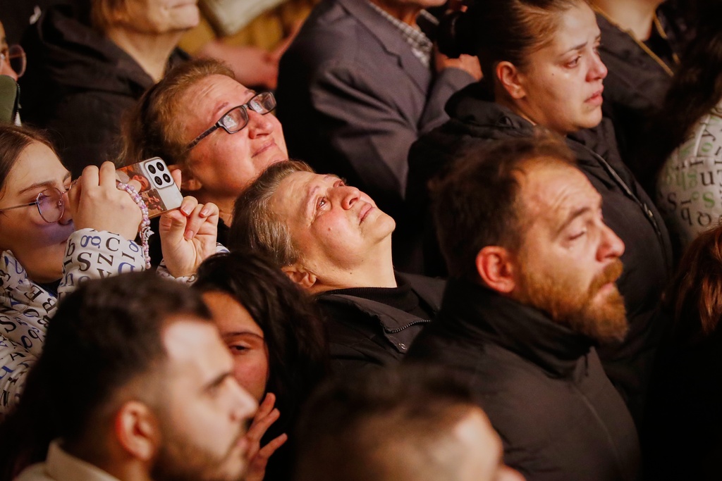 People attend the lighting of a Christmas tree at the Greek Orthodox Mar Elias Church, months after the church was the site of a deadly suicide bombing, in the Dweila neighborhood of Damascus, Syria, Tuesday, Dec. 23, 2025.(AP Photo/Omar Sanadiki)