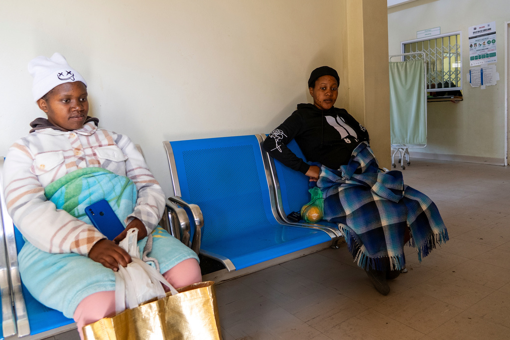 Expectant mothers Bonolo Tebelo, left, and Mpolokeng Mafereka wait for their appointments at Mpharane Health Centre in Mohale's Hoek district, Lesotho, Friday, July 10, 2026. (AP Photo/Kayleen Morgan)