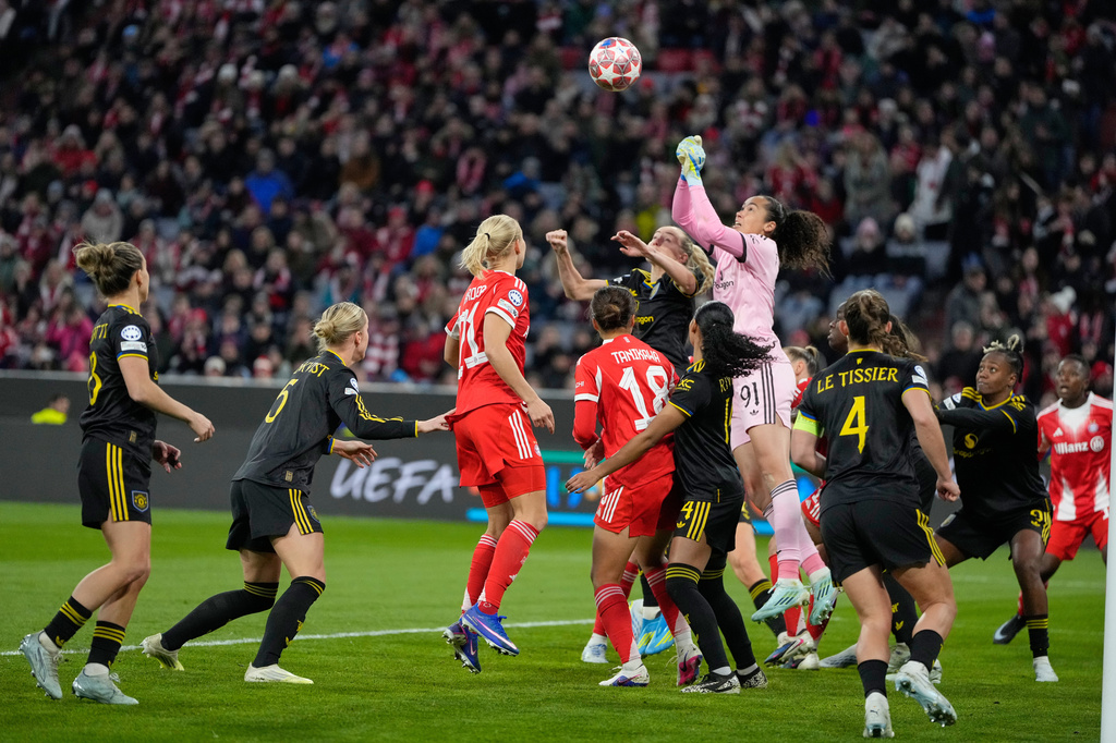 Manchester United's goalkeeper Phallon Tullis-Joyce leaps for the ball during the Women's Champions League quarterfinal second leg soccer match between Bayern Munich and Manchester United in Munich, Germany, Wednesday, April 1, 2026. (AP Photo/Matthias Schrader)