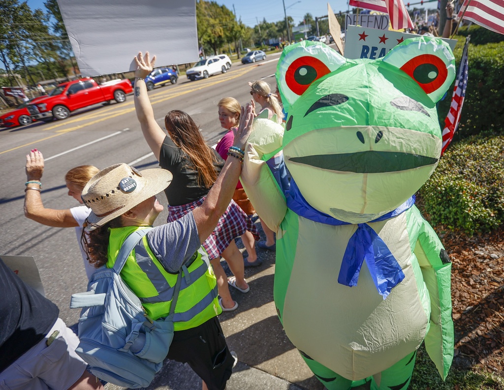 Teresa Clark, 51, of Palm Harbor wears a frog costume during a "No Kings" protest Saturday, Oct. 18, 2025 in Clearwater, Fla. (Chris Urso/Tampa Bay Times via AP)