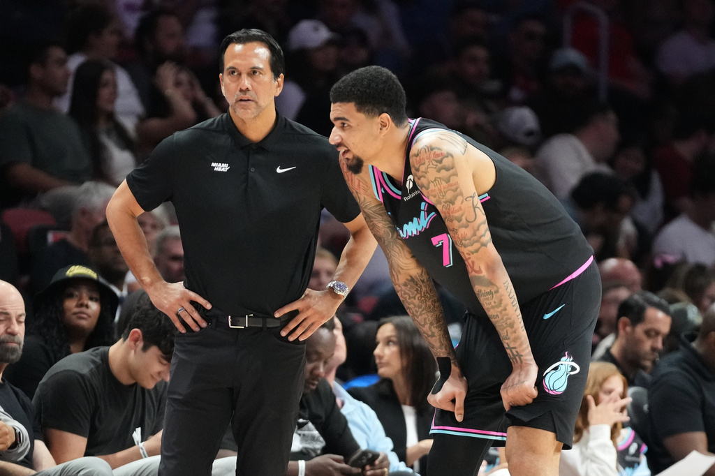 Miami Heat head coach Erik Spoelstra listens to center Kel'el Ware (7) during the second half of an NBA basketball game against the Washington Wizards Saturday, April 4, 2026, in Miami. (AP Photo/Marta Lavandier)