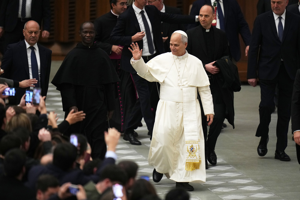 Pope Leo XIV waves faithfuls at the end of his weekly general audience in the Paul VI Hall at the Vatican, Wednesday, Jan. 7, 2026. (AP Photo/Alessandra Tarantino)