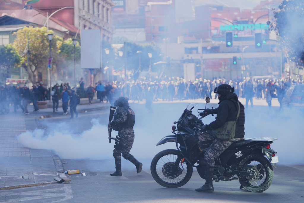 Artisanal miners clash with police during a protest to expanded mining areas in La Paz, Bolivia, Thursday, May 14, 2026. (AP Photo/Juan Karita)