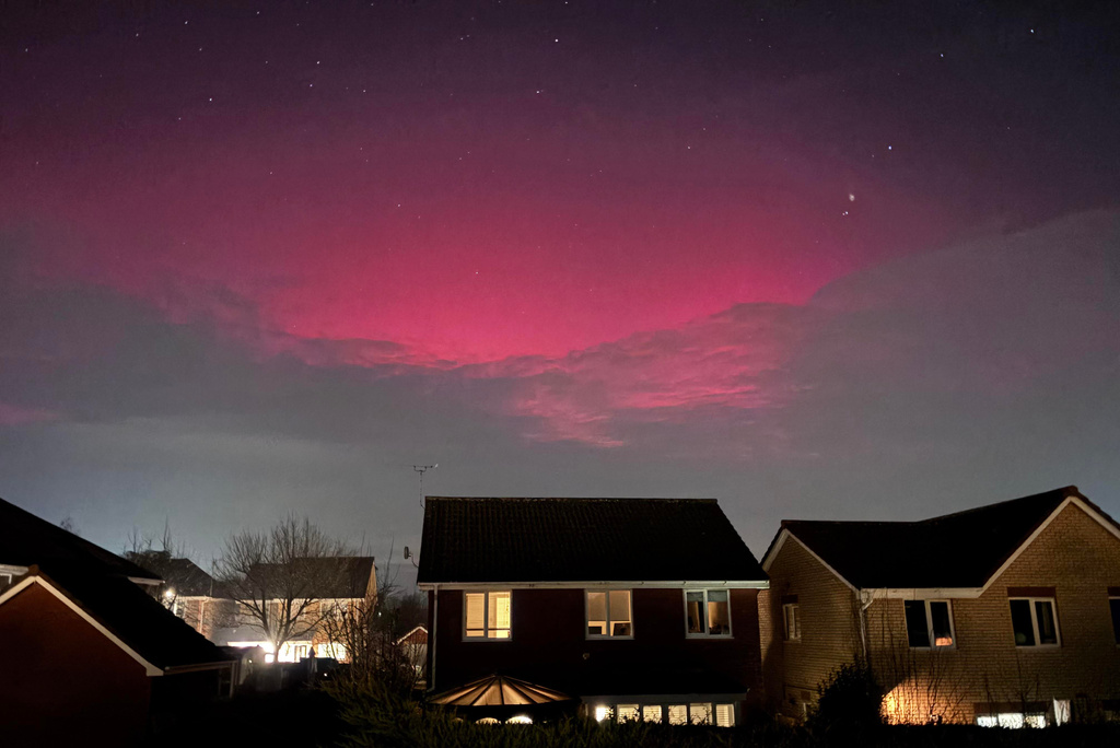 Northern lights illuminate the cloud cover over Rushmere St. Andrew, Ipswich, England, Monday Jan. 19, 2026. (Joe Pickover/PA via AP)