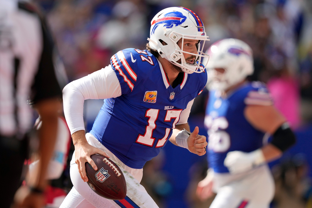 Buffalo Bills quarterback Josh Allen (17) celebrates after scoring a touchdown against the New England Patriots in the first half during an NFL football game in Orchard Park, N.Y., Sunday, Oct. 4, 2026. (AP Photo/Carolyn Kaster)