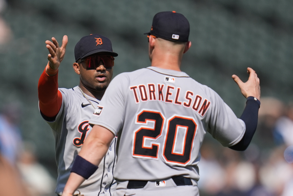 Detroit Tigers third baseman Andy Ibáñez, left,, and Spencer Torkelson (20) celebrate their team's win over the Chicago White Sox following a baseball game, Wednesday, Aug. 13, 2025, in Chicago. (AP Photo/Erin Hooley)