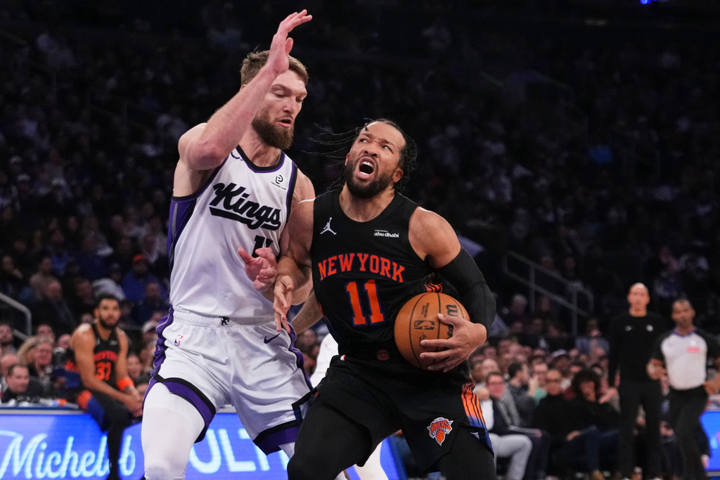 New York Knicks' Jalen Brunson (11) passes away from Sacramento Kings' Dylan Cardwell (32) during the first half of an NBA basketball game Tuesday, Jan. 27, 2026, in New York. (AP Photo/Frank Franklin II)