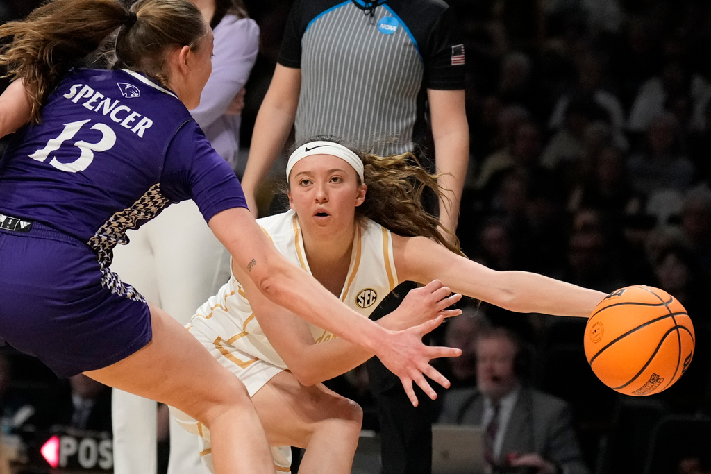 Vanderbilt guard Aubrey Galvan, right, passes ball around High Point guard Macy Spencer (13) during the first half in the first round of the NCAA college basketball tournament Saturday, March 21, 2026, in Nashville, Tenn. (AP Photo/George Walker IV)