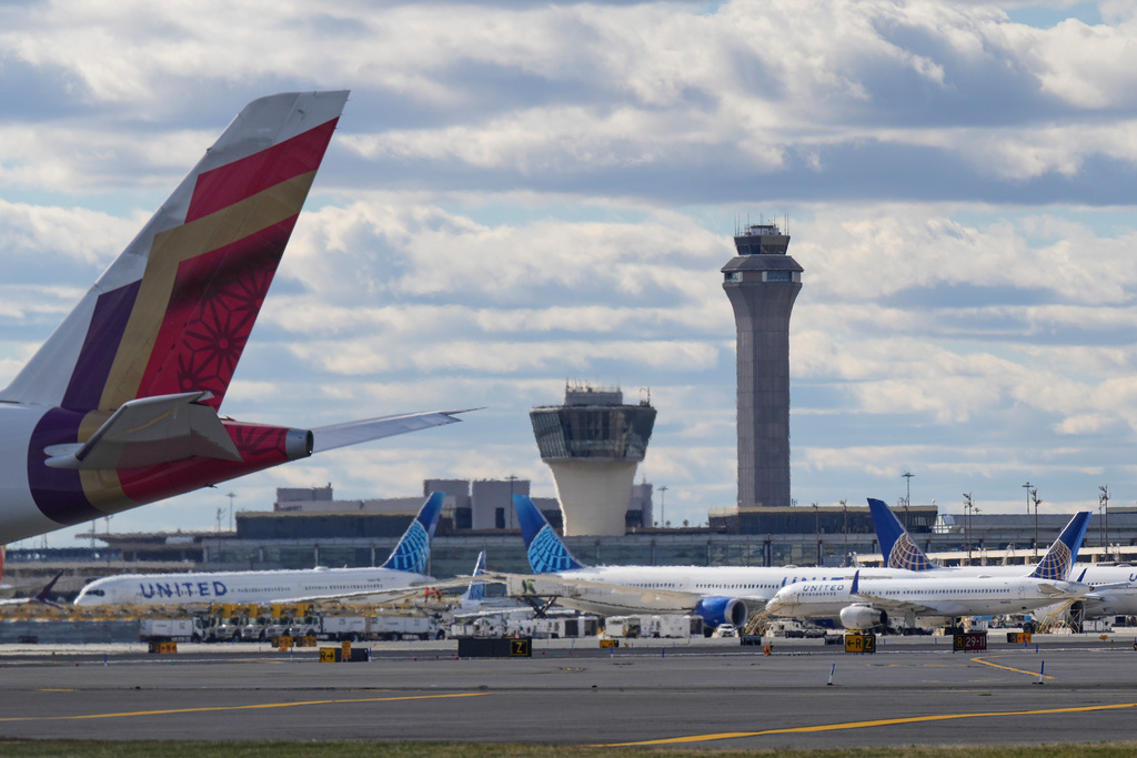 Planes taxi in front of an air traffic control tower at Newark International Airport in Newark, N.J., Thursday, Nov. 6, 2025. (AP Photo/Seth Wenig)
