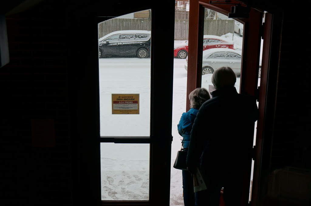 Signs saying that immigration agents have no right to enter without a warrant are posted on the doors of Holy Trinity Lutheran Church in Minneapolis on Sunday, Jan. 18, 2026. (AP Photo/Giovanna Dell'Orto)