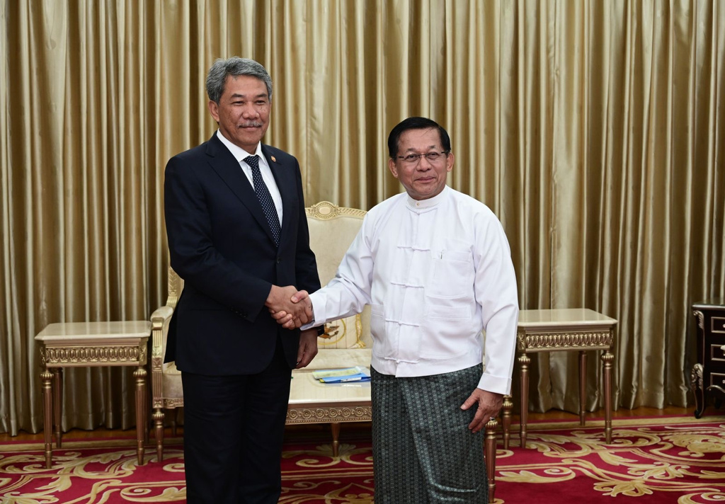 In this image provided by the Myanmar Military True News Information Team, Myanmar military leader Senior Gen. Min Aung Hlaing, right, shakes hands with Malaysian Foreign Minister Mohamad Hasan, left, during their meeting at the military guest house in Naypyitaw, Myanmar, Thursday, Oct. 9, 2025. (The Myanmar Military True News Information Team via AP)