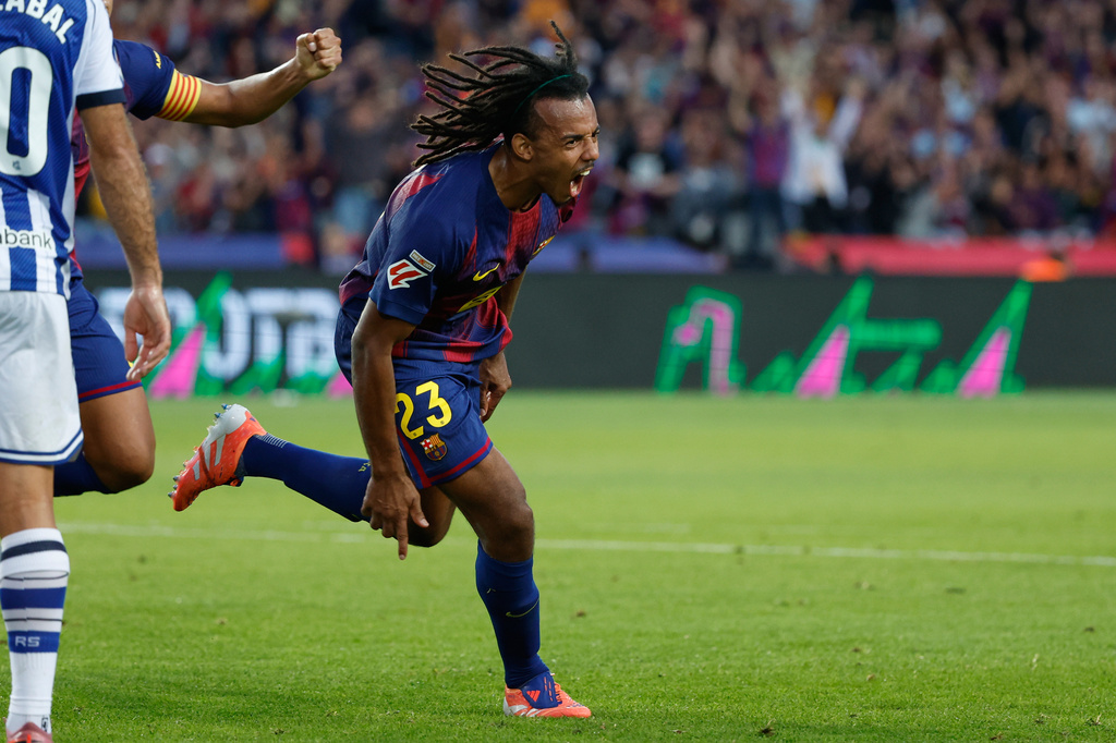 Barcelona's Jules Kounde celebrates scoring his side's first goal during a Spanish La Liga soccer match between FC Barcelona and Real Sociedad at the Lluis Companys Olympic Stadium in Barcelona, Spain, Sunday, Sept. 28, 2025. (AP Photo/Joan Monfort)