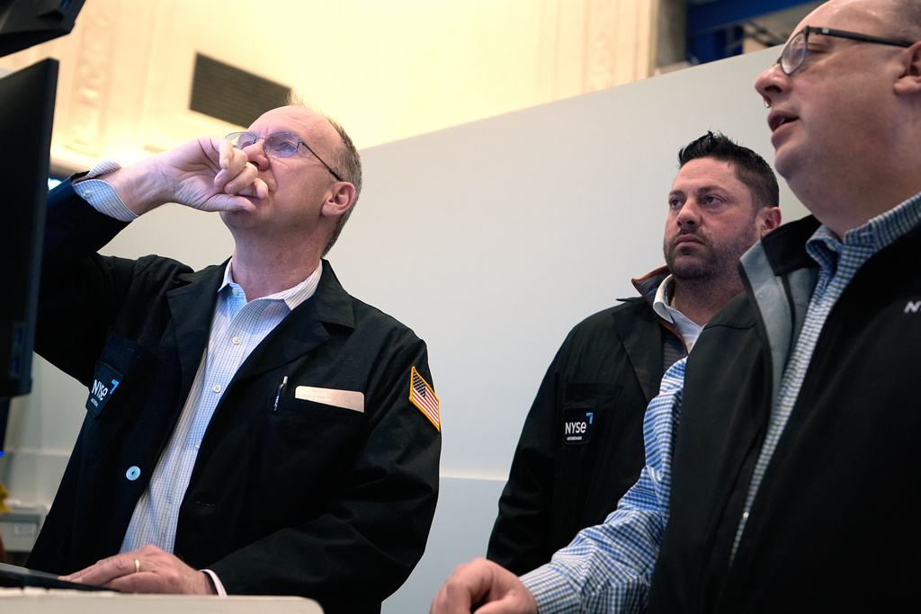 People work on the floor at the New York Stock Exchange in New York, Wednesday, March 18, 2026. (AP Photo/Seth Wenig)