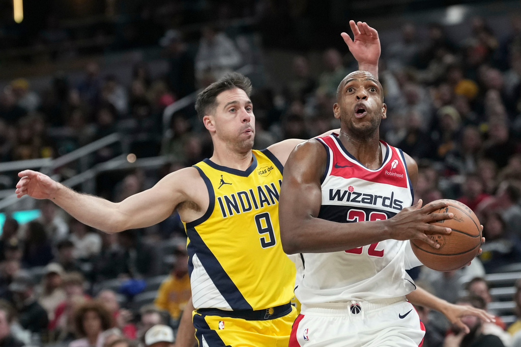 Washington Wizards forward Khris Middleton goes to the basket in front of Indiana Pacers guard T.J. McConnell (9) during the first half of an NBA Cup basketball game in Indianapolis, Friday, Nov. 28, 2025. (AP Photo/AJ Mast)