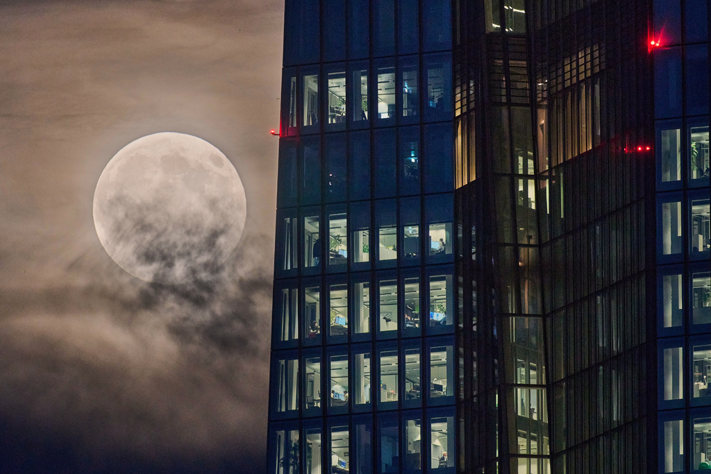 The beaver moon rises next to the European Central Bank in Frankfurt, Germany, Wednesday, Nov. 5, 2025. (AP Photo/Michael Probst)