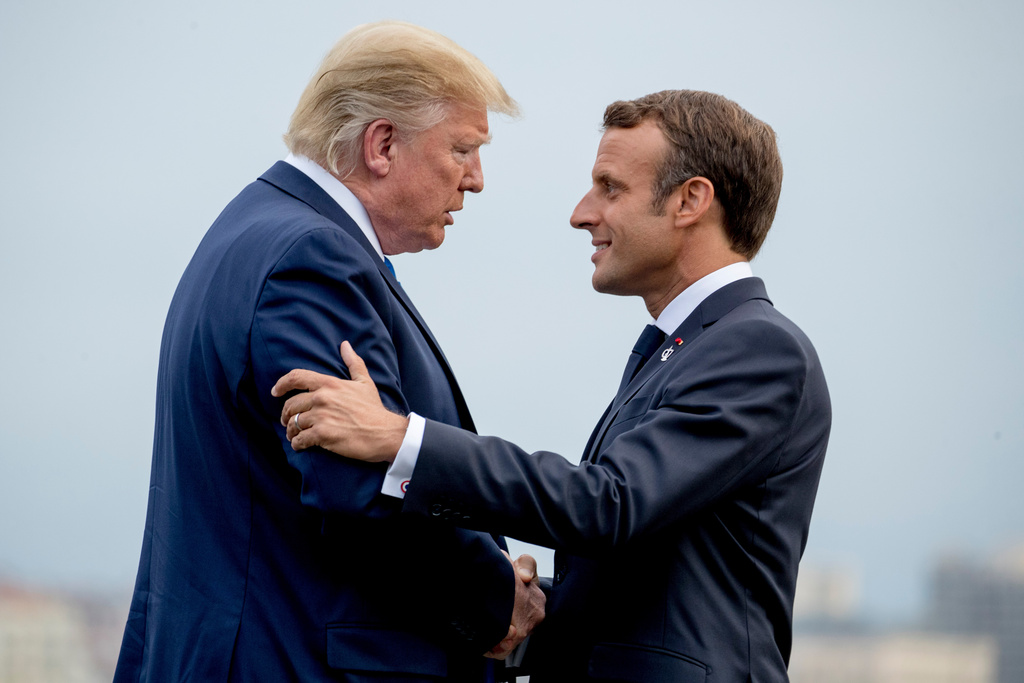 FILE - President Donald Trump and French President Emmanuel Macron greet each other at the G-7 summit before a dinner at the Lighthouse of Biarritz, France, Aug. 24, 2019. (AP Photo/Andrew Harnik, File)