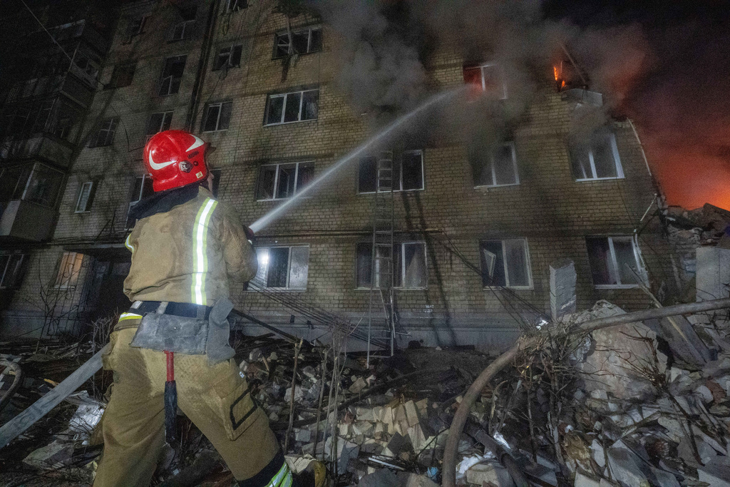 Firefighters put out the fire in an multi-storey apartment building following a Russian missile attack in Kharkiv, Ukraine, Saturday, March 7, 2026. (AP Photo/Andrii Marienko)