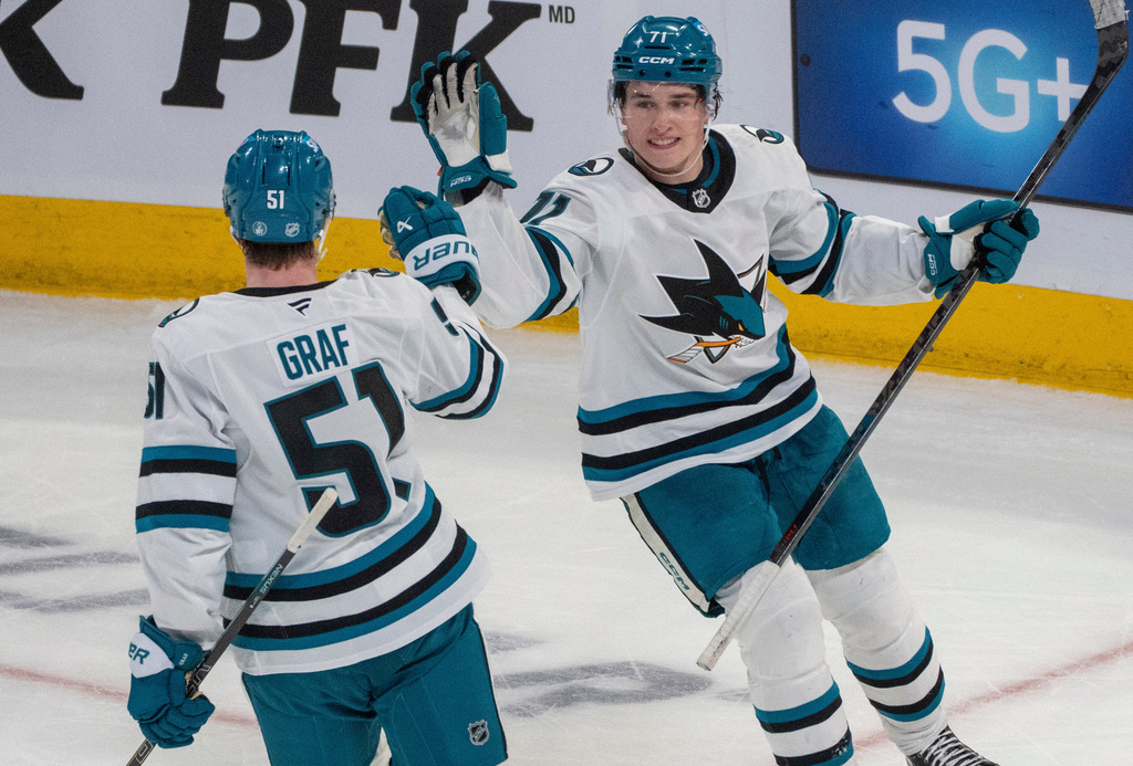 San Jose Sharks' Macklin Celebrini (71) celebrates his empty net goal with teammate Collin Graf (51) against the Montreal Canadiens during third period NHL hockey action in Montreal on Saturday, March 14, 2026. (Christinne Muschi/The Canadian Press via AP)