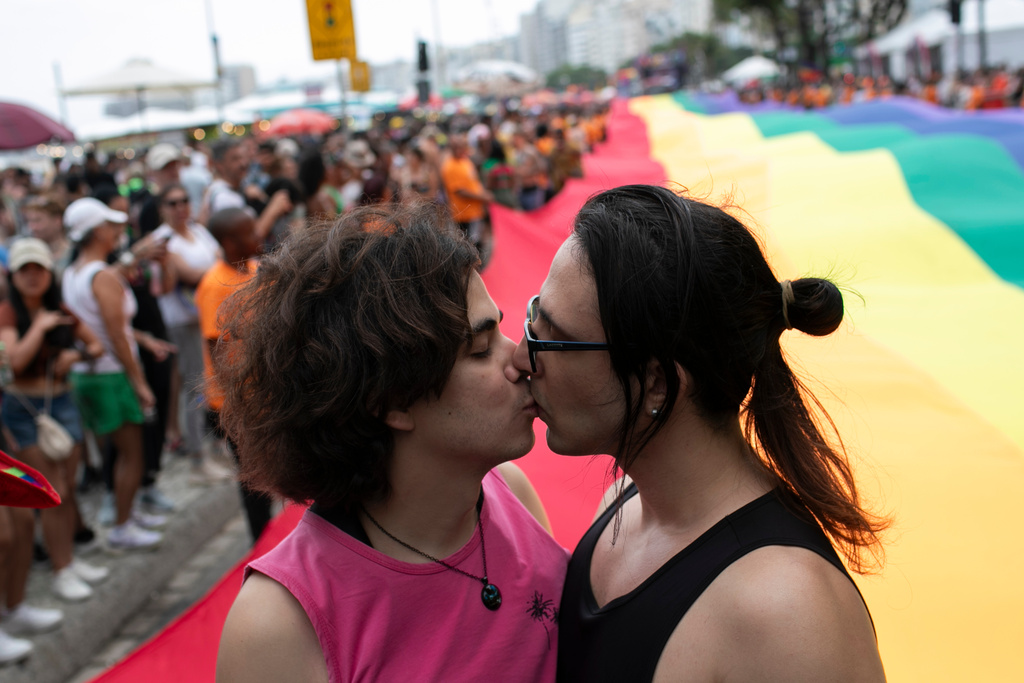 People kiss during the annual Rio Pride parade along Copacabana Beach in Rio de Janeiro, Sunday, Nov. 23, 2025. (AP Photo/Bruna Prado)