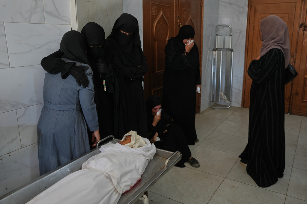 Palestinian women mourn over the body of 10-year-old Amir Shaaban, who was killed in an Israeli military strike, before his funeral at Nasser Hospital in Khan Younis, southern Gaza Strip, Wednesday, July 8, 2026. (AP Photo/Abdel Kareem Hana)
